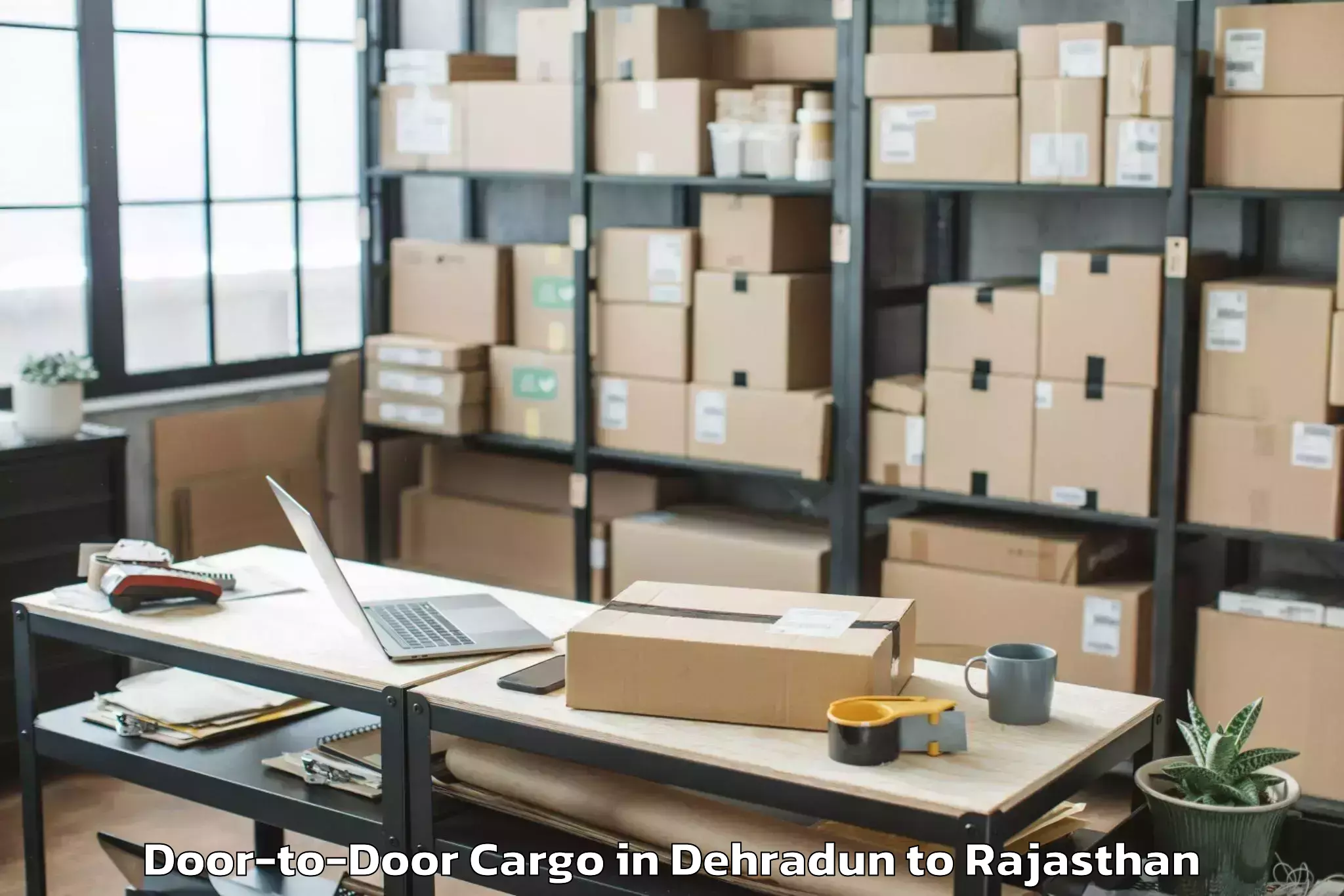 Professional Dehradun to Hindaun Door To Door Cargo